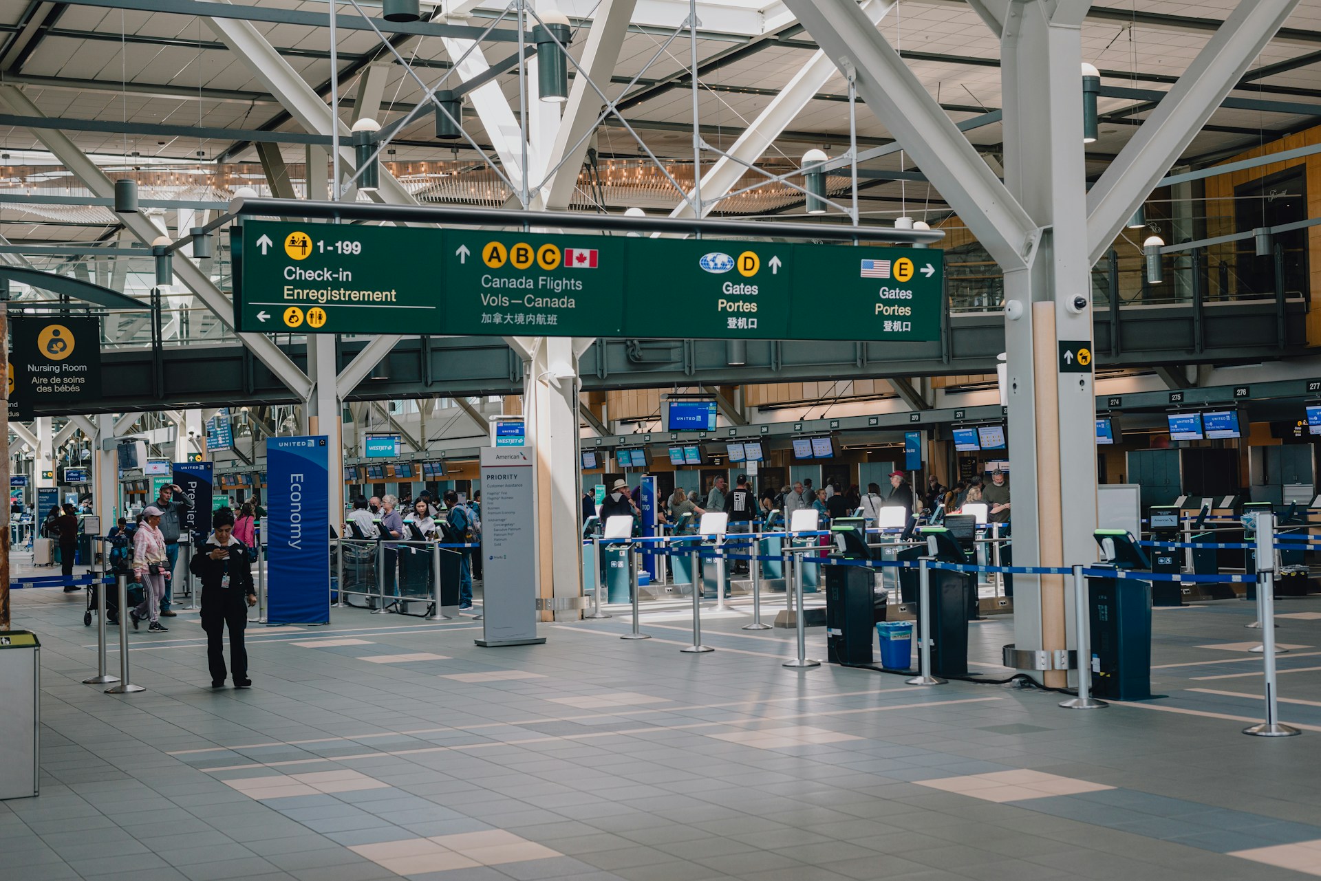 Travelers checking in at a busy airport terminal